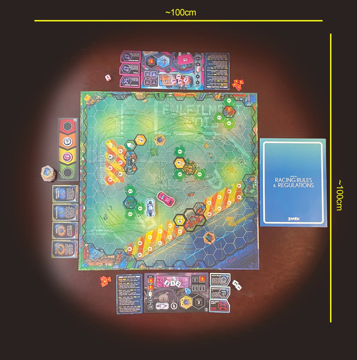 A birds eye view of the two player board for Joyride, set up for two players. Measurements around the image indicate table space as approximately 100 by 100 centimeters.
