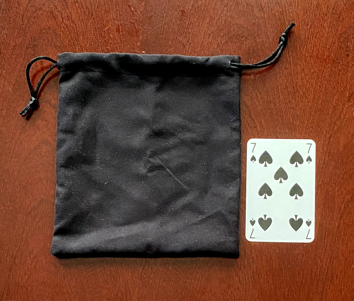 	
The cloth shot bag next to a standard playing card for reference. It is roughly four times the size of the playing card.